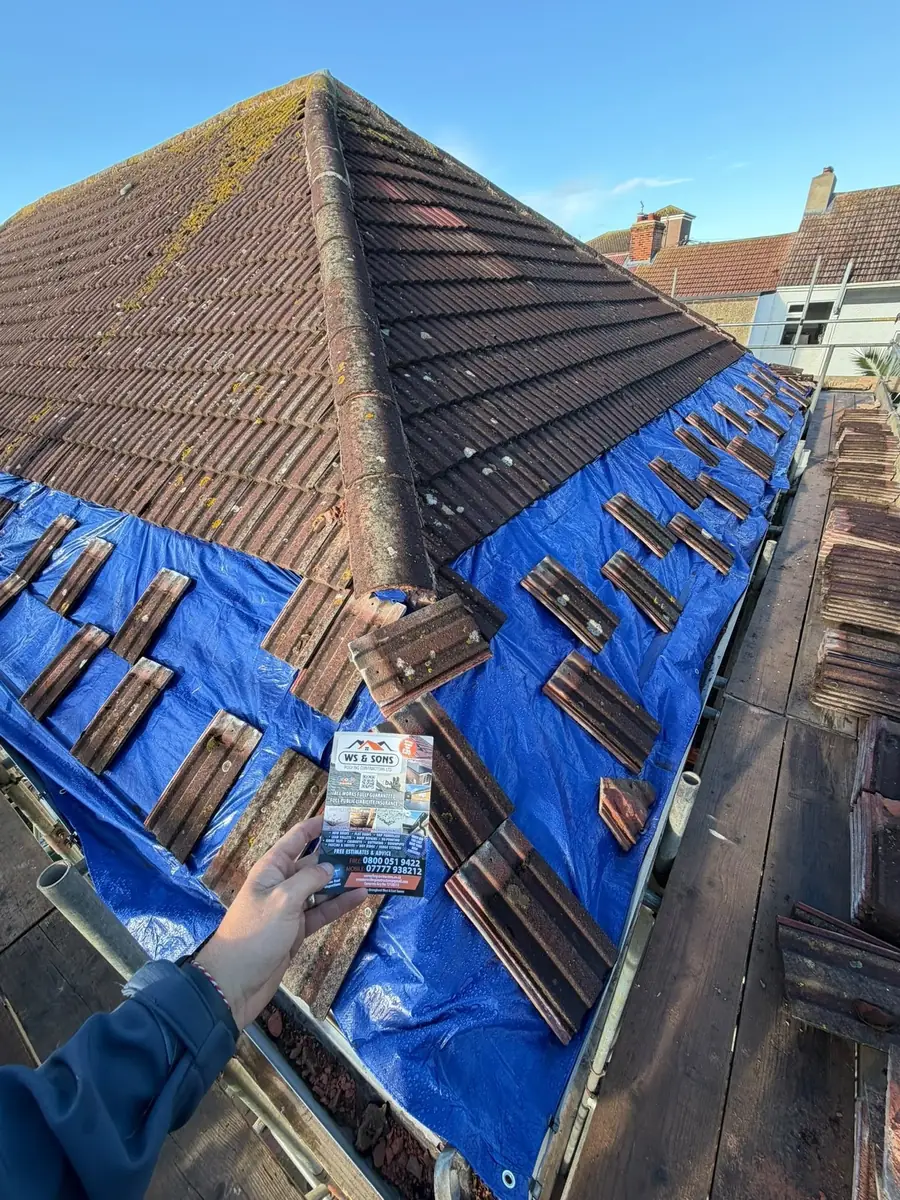 Tiles going on over blue membrane, flyer in shot