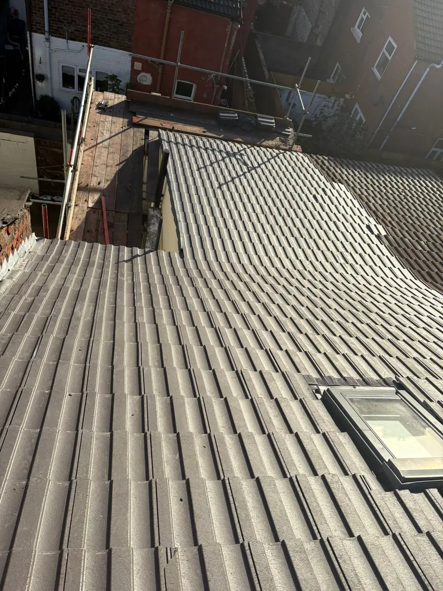 New brown concrete tiles laid around a roof window