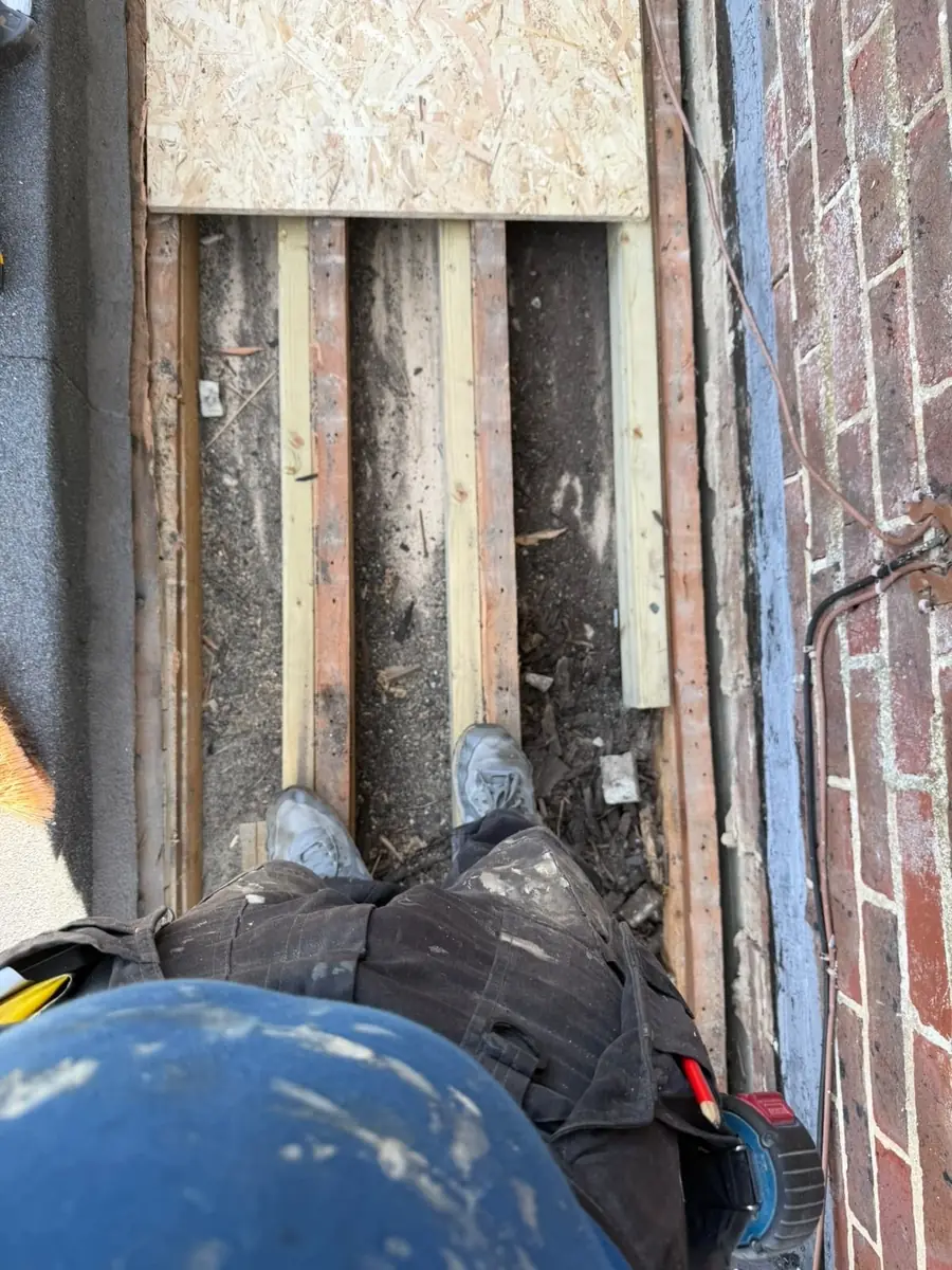 Flat roof joists exposed with the new deck going down