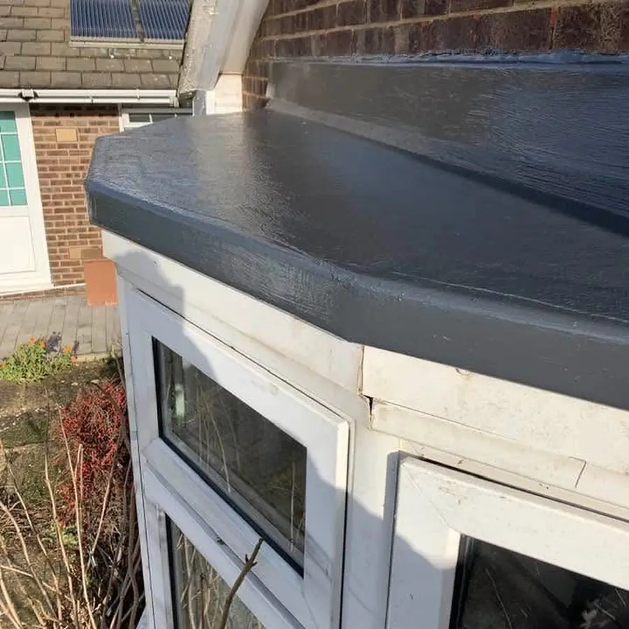 Grey flat roof over a bay window with a dressed edge