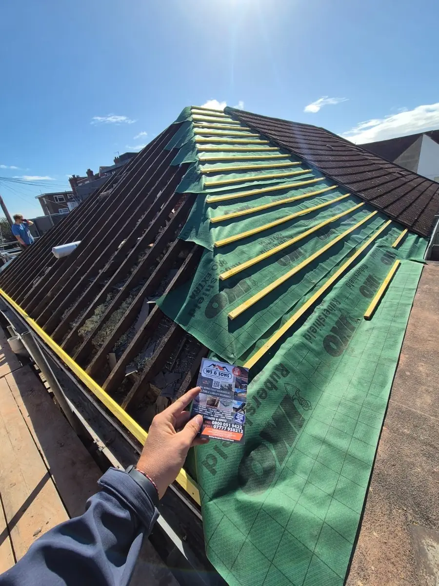 Hip roof with new green membrane and battens, flyer in shot