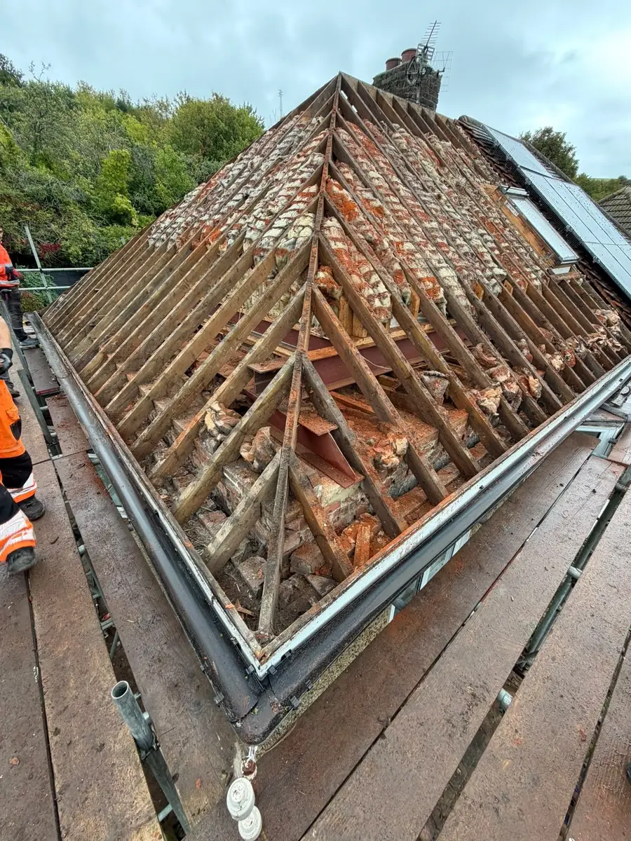 Hip roof open to the timbers during a full re-roof