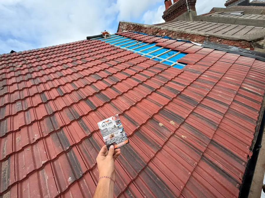 Red tile re-roof almost finished, flyer in shot