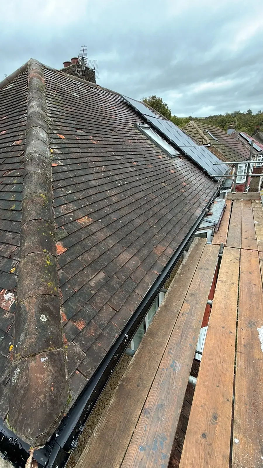 Roof slope stripped, perished old felt still on the rafters