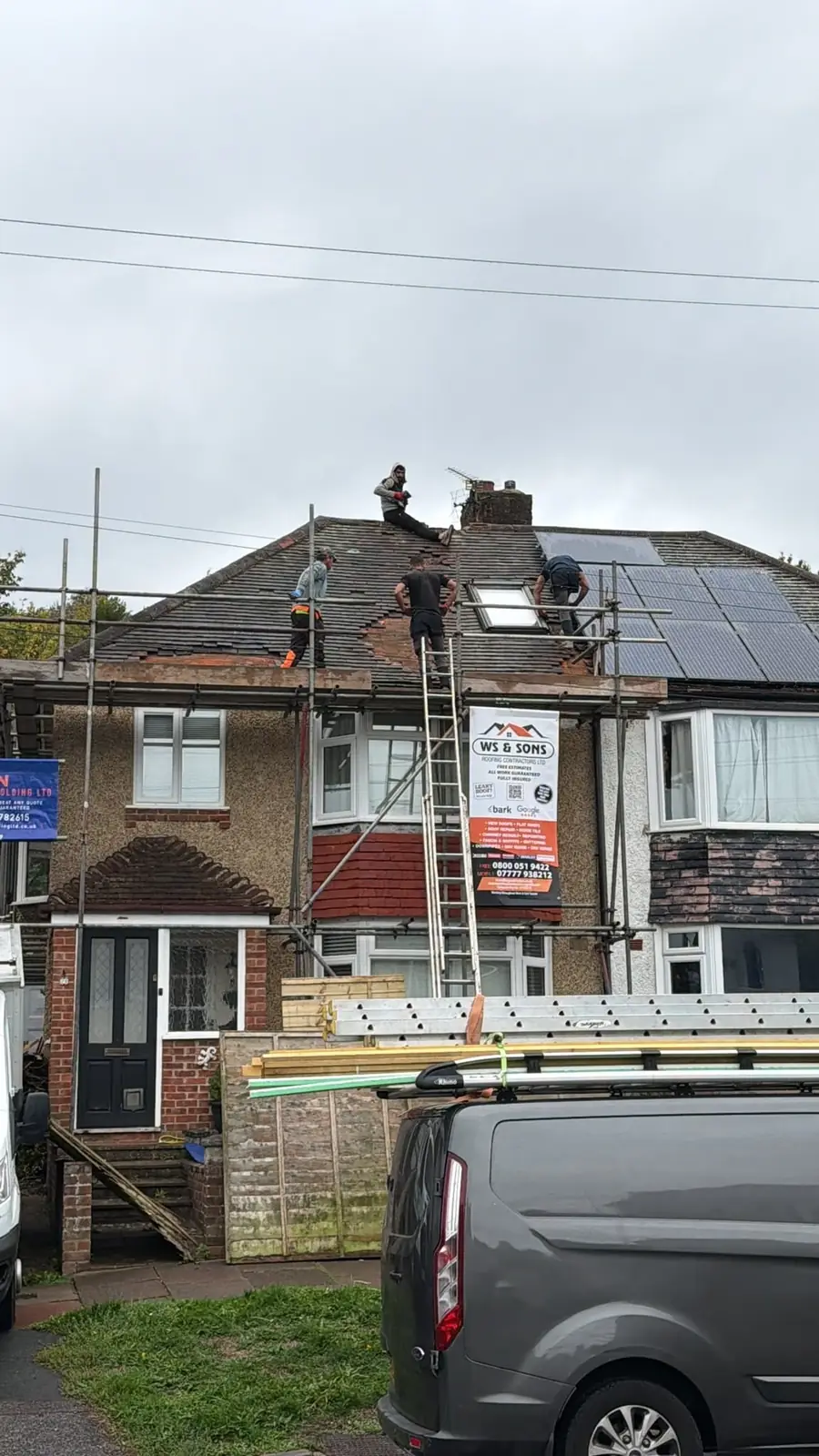 Roofers at the ridge of a semi during a re-roof