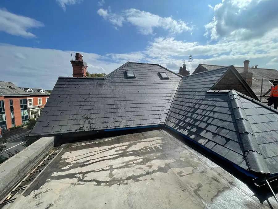 Slate roof finished above a flat roof at the back of a house
