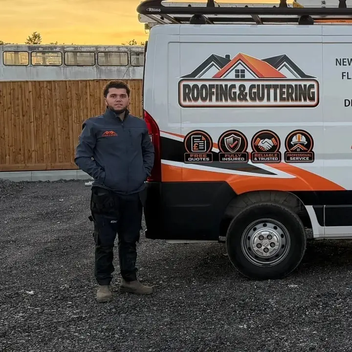 William, owner of WS & Sons Roofing Contractors, beside a work van